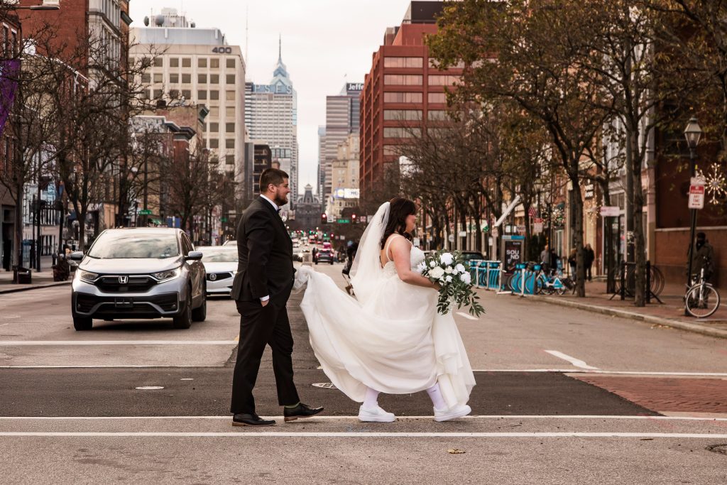 Bride and groom walking across a Philadelphia street captured by In The Mix Event Group wedding photography.